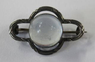 A silver bar brooch, set with a cabochon moon stone, marked 925