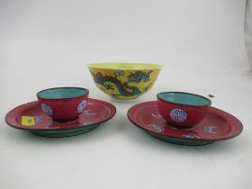 A pair of Minyao style miniature tea bowls and saucers, decorated with bats and circular motifs on a