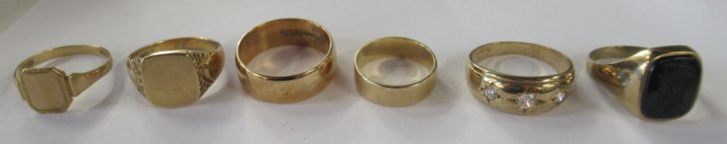 A 9ct wedding band, together with two 9ct gold signet rings, weight 16g, together with an onyx set
