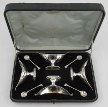 A Victorian cased silver four piece condiment set, comprising four oval pedestal salts and four