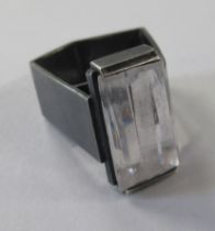 A contemporary silver dress ring, set with a rectangular clear stone