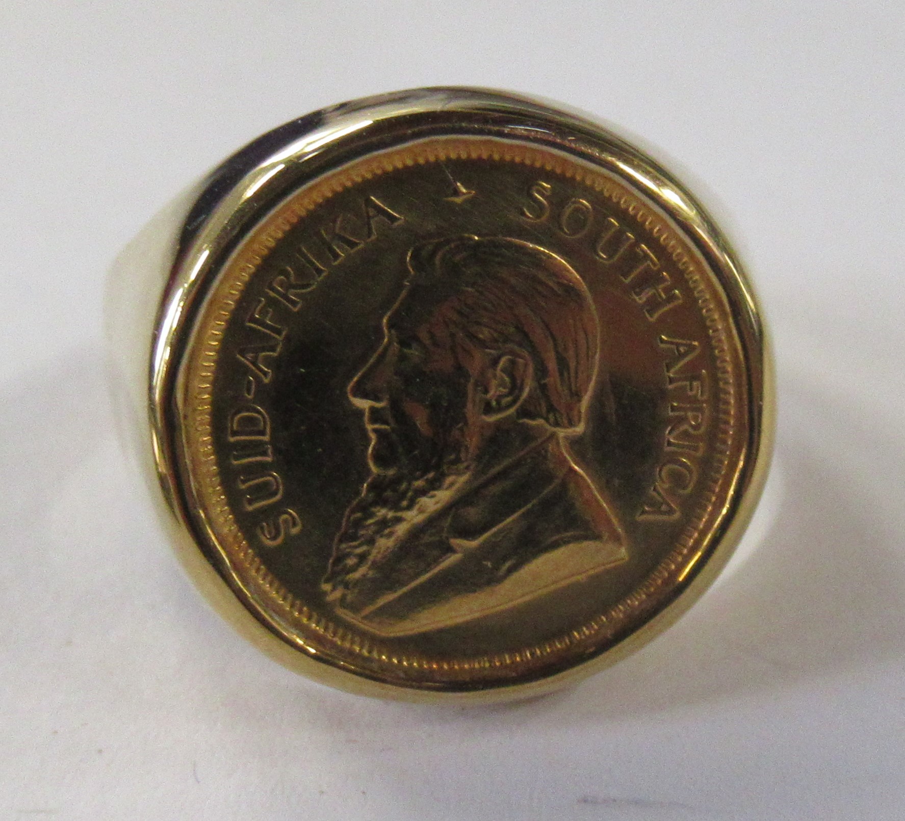A 9ct ring, set 1/10 oz South African Krugerrand, dated 1990
