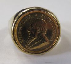 A 9ct ring, set 1/10 oz South African Krugerrand, dated 1990