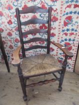 A ladder back country arm chair