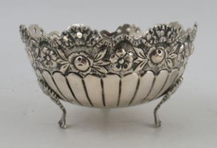 A Continental silver bowl, with pierced and embossed decoration to the shaped edge, raised on