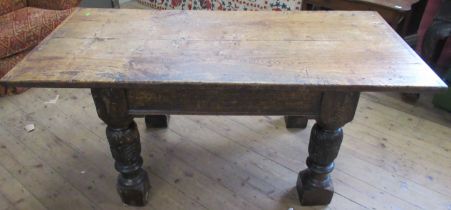 An Antique oak dining table, raised on four carved turned legs, width 32ins, length 68ins, height