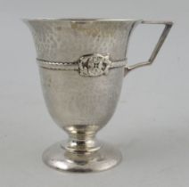 A George V Arts and Crafts silver christening mug, with hammered and applied decoration,