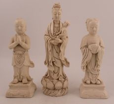 A Chinese 20th century Blanc de China figure, of Guanyin with two attendants, height 13ins and down