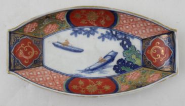 A Japanese Imari dish, of oval form, decorated with figures in boats, width 8.5ins