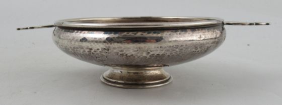 A George V Arts and Crafts silver quaich, with pierced handles and hammered decoration, Birmingham