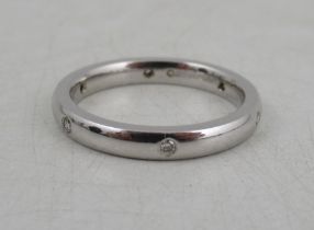 An 18ct white gold wedding band, set with diamonds, weight 4.6g