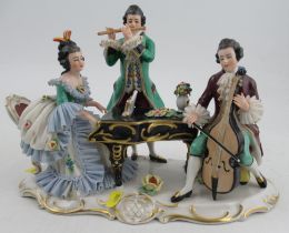 A 20th century German porcelain figure group, of three musicians, width 11ins