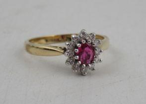 An 18ct gold ruby and diamond cluster ring, weight 3.7g