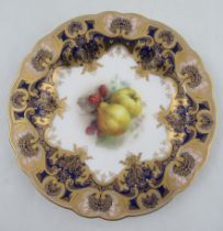 A Royal Worcester cabinet plate, the centre decorated with fruit by Sebright, with a rich dark