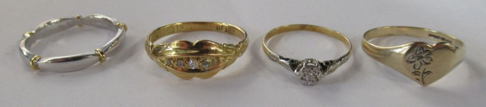 An 18ct white and yellow gold Millennium band, together with a solitaire diamond ring, an 18ct