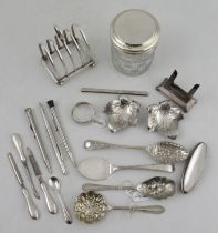 A silver and glass dressing table jar, together with a silver toast rack and other metalware