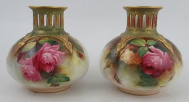 A pair of Royal Worcester vases, with pierced gilded necks, the body decorated with roses by Austin,