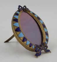 Christian Dior, an oval gilt metal and enamel picture frame, with bow detail, having an easel