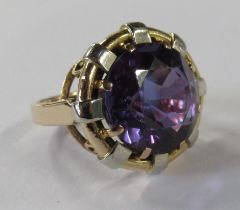 A gold ring, set with a synthetic colour changing sapphire