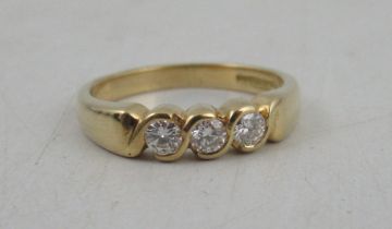 An 18ct gold three stone diamond ring, weight 4.5g, diamond approximately 0.09ct each, total