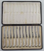 A cased set of twelves silver handles pistol grip butter knives, the steel blades and box marked for