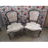 A pair of simulated bamboo open arm chairs,