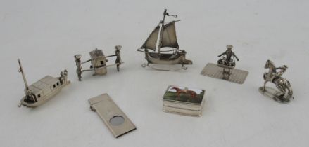 A collection of white metal models, to include a sedan chair carried by two figures, two boats, a