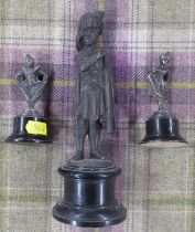 A metal model, of a Scottish military figure, together with two other metal models