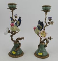 A pair of modern candlesticks, in porcelain and gilt metal, modelled as birds in a tree with