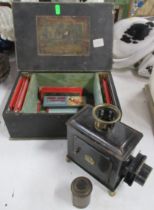 A 19th century childs tin plate magic lantern, and slides, in wooden box
