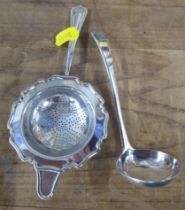 A Georgian silver sauce ladle, together with a silver tea strainer