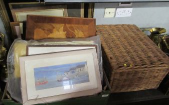 A collection of prints, magazines and a wicker hamper
