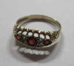 A 9ct gold ring, set with rubies and diamond, weight 1g