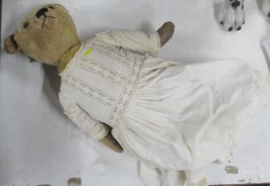 A teddy bear, height 24ins, wearing a christening gown