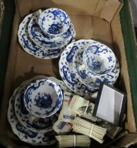 A part tea set decorated in with a blue dragon, together with cigarette cards
