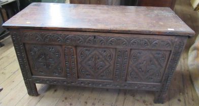 An  antique oak coffer having carved fielded panels to the front, width 51ins, length 22ins,