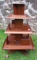 A revolving 3 tiered stand, stamped "this stand is the property of the Mazawattee tea company".