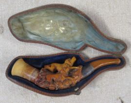 A cased carved Meerschaum pipe, carved with two dogs