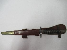 A World War II Commando fighting knife, or dagger, with ribbed handle, and sheath