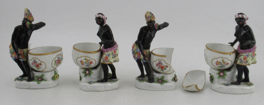 Two pairs of 19th century hard paste porcelain table salts, modelled as a black male and female in