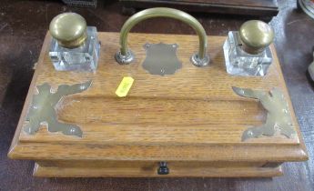 An oak and brass mounted desk stand, fitted with a drawer, together with an oak cased mantel clock