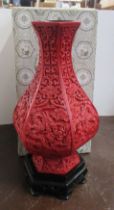 A modern cinnabar lacquer style vase and stand, height 12ins including stand, boxed