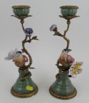 A pair of modern candlesticks, in porcelain and gilt metal, modelled as birds in a tree with