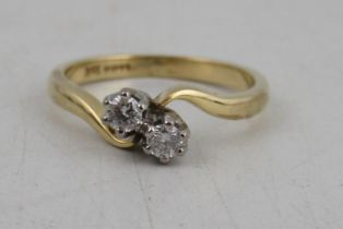 An 18ct gold two stone diamond cross over ring, weight 4g, diamonds approximately 0.09ct each, total
