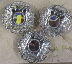 A set of three silver small dishes, with embossed decoration