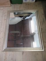 A rectangular mirror within a moulded silvered frame mirror size 45.5ins x 34.5 ins