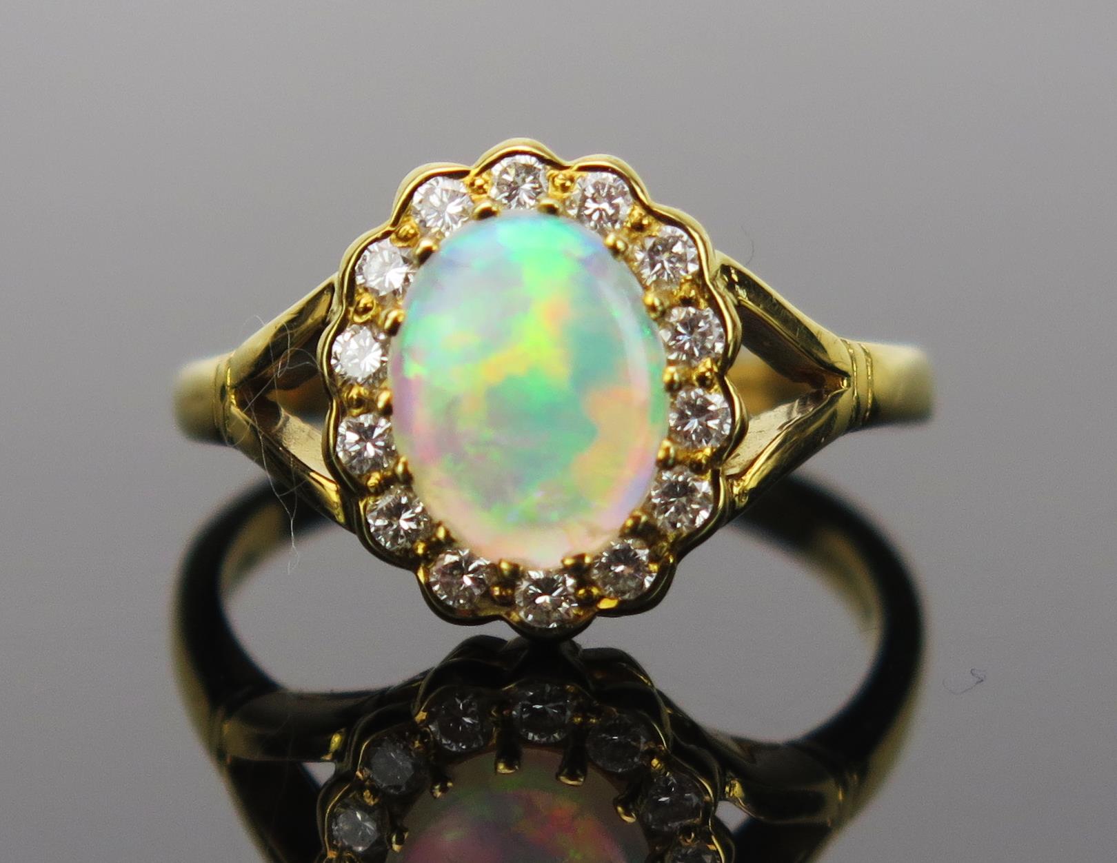 White Opal and Diamond Cluster Ring in an 18ct hallmarked gold setting, 9x7mm central stone, 13x11mm - Image 4 of 5