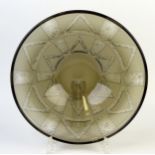 A smoked Art glass dish with geometric pattern decoration, 30cm diameter.