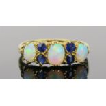 White Opal and Sapphire Ring in an 18ct hallmarked gold setting, 17mm head, size K.75, Birmingham