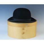 A gentleman's bowler hat by B V Co, contained in a card hat box.